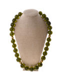 A necklace of greenish amber balls