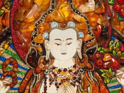 Panel with amber in combination with lurex and Swarovski stones “Four-armed Avalokiteshvara”