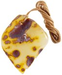 Light amber pendant with carved design