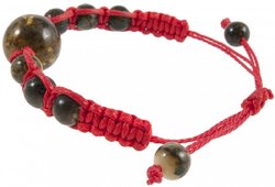 Amulet bracelet with a red thread and greenish amber balls
